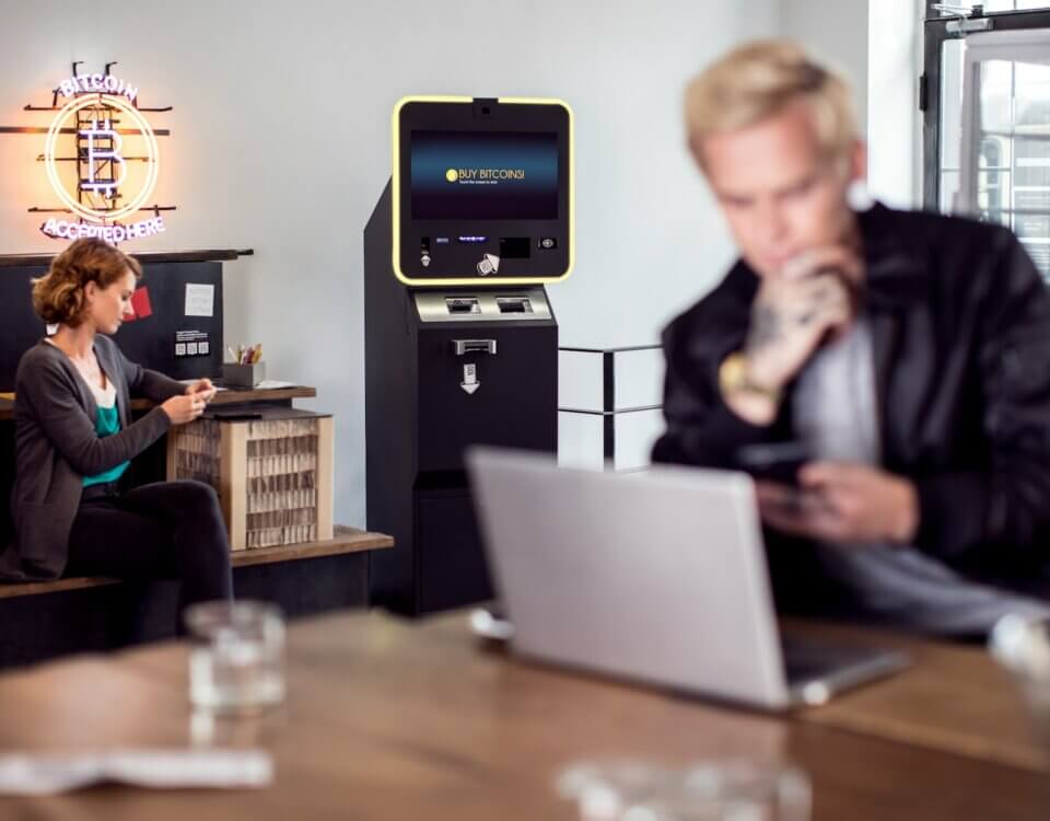 a man and a woman sitting at a table with a laptop